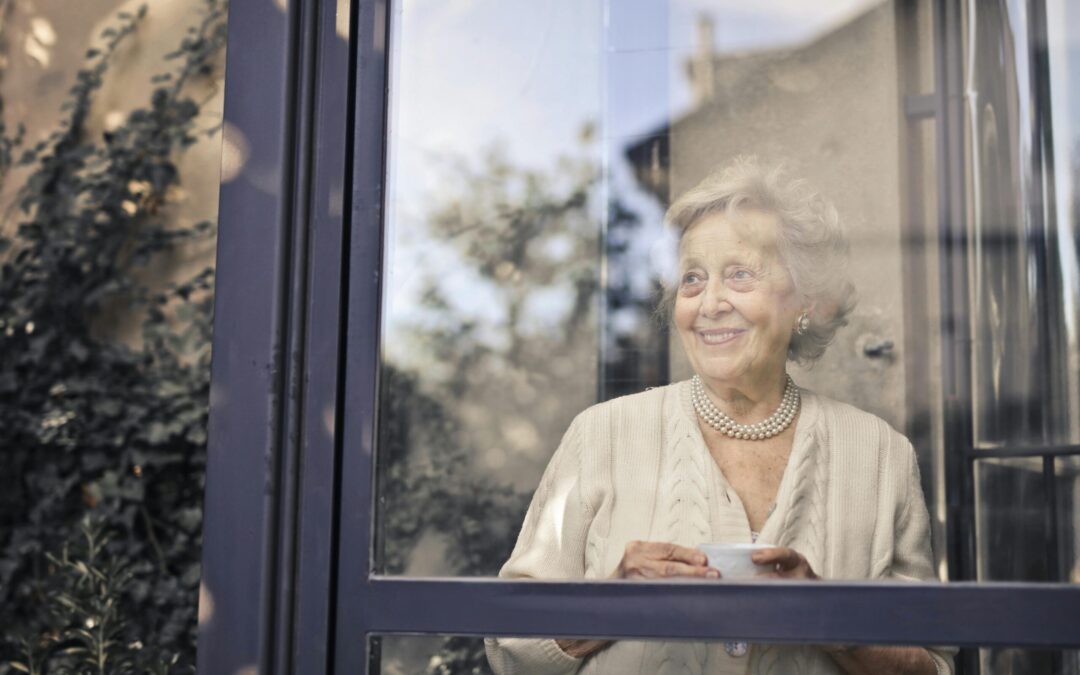 Elderly woman looking out the window